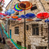Umbrellas hanging above a narrow staircase in Amman, Jordan.